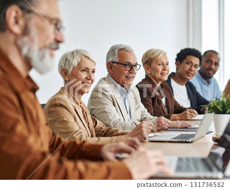 AI generated image of seniors giving feedback on a new AI health device in a modern conference room. A diverse group of older adults testing technology for the future of healthcare. 131736582