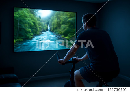 AI generated image of a person on a stationary bike in a dark home theater room with a nature documentary on the screen. Cool blue lighting creates a relaxing and focused atmosphere. 131736701