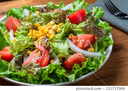 Colourful salad of lettuce, tomato and corn Colourful salad of lettuce, tomato and corn 131737000