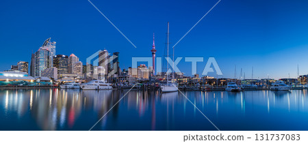 Sky Tower and Yacht Harbour cityscape seen from the Auckland Viaduct, New Zealand 131737083