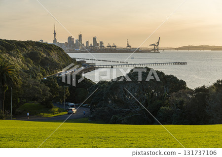 View of the Sky Tower, harbor and sunset from Bastion Point in Auckland, New Zealand View of the Sky Tower, harbor and sunset from Bastion Point in Auckland, New Zealand 131737106