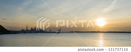 Auckland, New Zealand: Sky Tower, harbor view and the setting sun 131737110