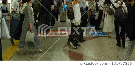Tourists passing through the Shinkansen ticket gates at Nagoya Station in summer 131737536