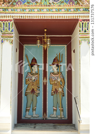 Wooden doors carved with the shape of guards at Wat Phra Sri Rattana Satsadaram or Wat Phra Kaew,is one of the most popular tourists destination in Thailand. Wooden doors carved with the shape of guards at Wat Phra Sri Rattana Satsadaram or Wat Phra Kaew,is one of the most popular tourists destination in Thailand. 131737576