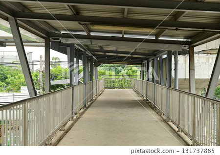 Horizontal Foot Bridge Crossing. A muted footbridge pathway at Bangkok capital city in Thailand. Horizontal Foot Bridge Crossing. A muted footbridge pathway at Bangkok capital city in Thailand. 131737865