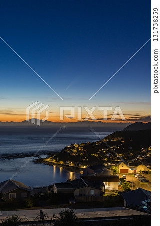 Comet Atlas streaking through the sunset sky as seen from Island Bay in Wellington, New Zealand Comet Atlas streaking through the sunset sky as seen from Island Bay in Wellington, New Zealand 131738259