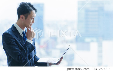 A company employee in his 40s using a computer A company employee in his 40s using a computer 131739098