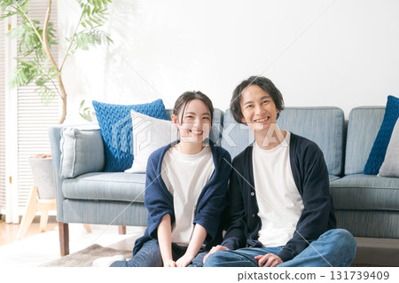 Young men and women relaxing at home Young men and women relaxing at home 131739409