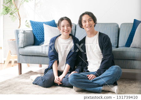 Young men and women relaxing at home Young men and women relaxing at home 131739410