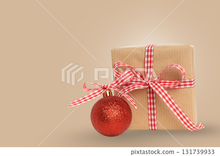 Christmas decor: gift with red ribbon and ornament Christmas decor: gift with red ribbon and ornament 131739933