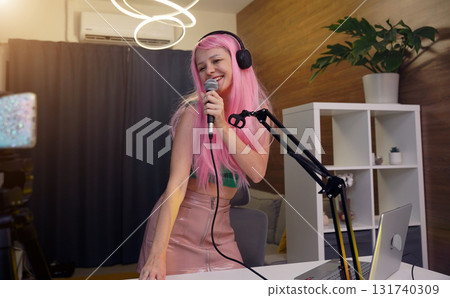 Beautiful young singer and musician broadcast from her home studio 131740309