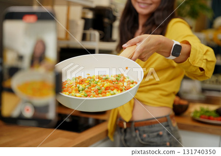 Young woman is broadcasting live from workshop how to prepare a vegetarian food 131740350