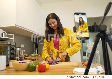 Young woman is broadcasting live from workshop how to prepare a vegetarian food 131740353
