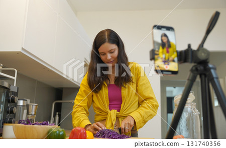 Young woman is broadcasting live from workshop how to prepare a vegetarian food 131740356