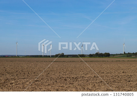 Wind Turbines on Green Field Under Clear Sky Wind Turbines on Green Field Under Clear Sky 131740805