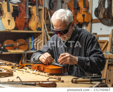 AI generated image of an elderly luthier working in a classic violin workshop using augmented reality glasses for precision. The blend of tradition and modern technology creates a perfect harmony. 131740967