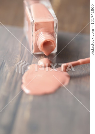Beige-pink nail polish spilled from a container 131741000