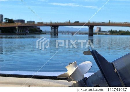 A view of the propeller of a boat moored on the Seta River and Seta no Karahashi Bridge in the evening A view of the propeller of a boat moored on the Seta River and Seta no Karahashi Bridge in the evening 131741087