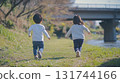 Children running along the river 131744166