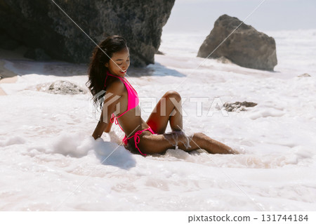 Beauty woman in bikini at tropical beach. Sexy lady in ocean foam 131744184