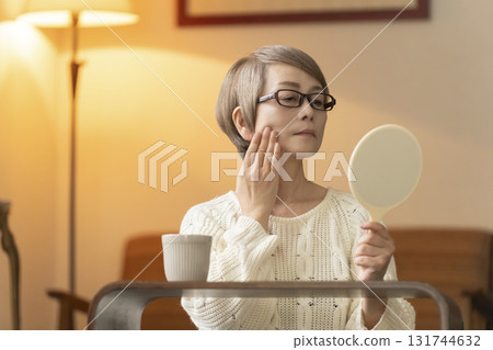 晚上，老年婦女在客廳看著手鏡 131744632