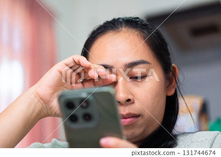 Asian Woman Feeling Eye Strain from Using Smartphone Asian Woman Feeling Eye Strain from Using Smartphone 131744674