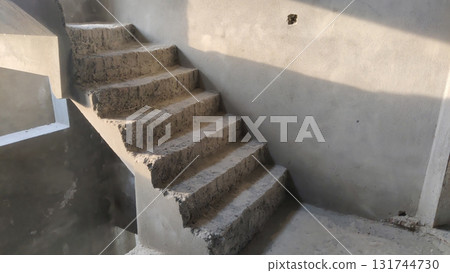 View of unfinished concrete staircase in a building under construction area View of unfinished concrete staircase in a building under construction area 131744730