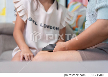Asian Mother Arguing with Daughter Over Smartphone Use at Home Asian Mother Arguing with Daughter Over Smartphone Use at Home 131745009