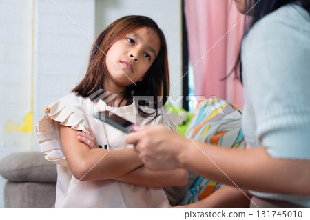 Asian Mother Arguing with Daughter Over Smartphone Use at Home 131745010