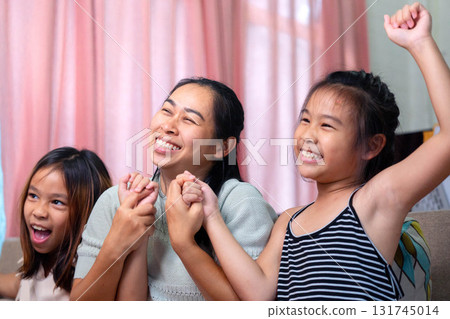 Asian Mother and Daughters Raising Hands and Celebrating Happiness Together Asian Mother and Daughters Raising Hands and Celebrating Happiness Together 131745014