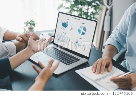 Business data analysis concept with colleagues reviewing financial report on laptop, pointing at chart with growth graph, teamwork discussing statistics, planning strategy and corporate success. Business data analysis concept with colleagues reviewing financial report on laptop, pointing at chart with growth graph, teamwork discussing statistics, planning strategy and corporate success. 131745166
