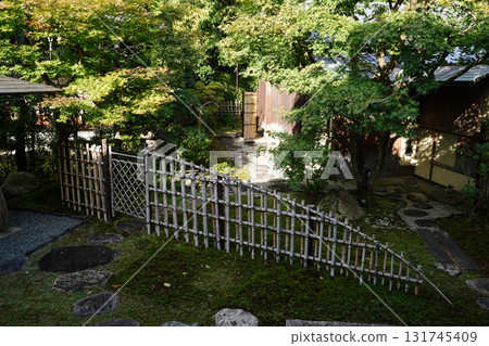 A Japanese garden with a bamboo fence A Japanese garden with a bamboo fence 131745409