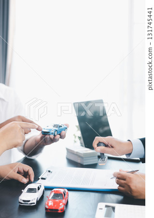 Businessman stamping approved contract for car loan agreement, concept of finance approval, vehicle purchase, leasing, or insurance, symbol of trust, validation, professional deal. approved contract. Businessman stamping approved contract for car loan agreement, concept of finance approval, vehicle purchase, leasing, or insurance, symbol of trust, validation, professional deal. approved contract. 131745441