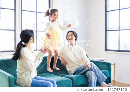 A family relaxing in the living room A family relaxing in the living room 131747120