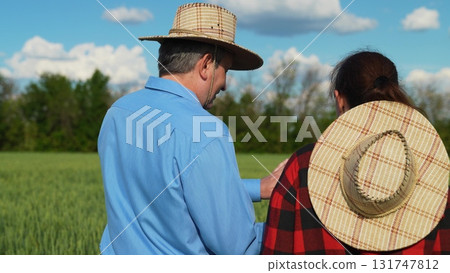 Technology adoption in agriculture, Father and daughter on farm, Farming teamwork, Rural lifestyle, Crop monitoring with tablet, Agriculture of the future, Digital transformation in farming, Modern 131747812