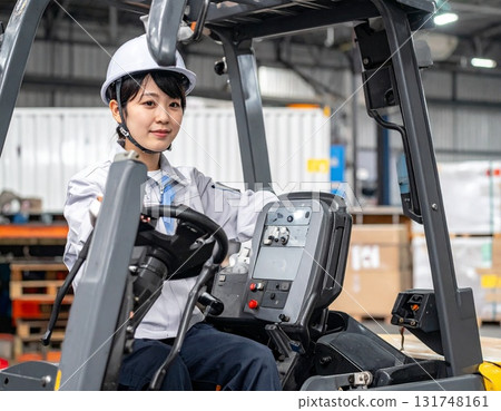 Female worker driving a forklift 131748161