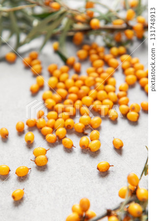 Sea buckthorn berries scattered on gray background Sea buckthorn berries scattered on gray background 131748913