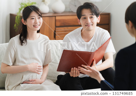 A couple listening to an explanation of insurance Lifestyle image A couple listening to an explanation of insurance Lifestyle image 131749685