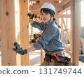 A young female carpenter building a house, a scene from a construction site focusing on her facial expression and hands while working 131749744