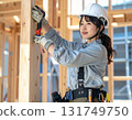 A young female carpenter building a house, a scene from a construction site focusing on her facial expression and hands while working 131749750