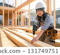 A young female carpenter building a house, a scene from a construction site focusing on her facial expression and hands while working 131749751