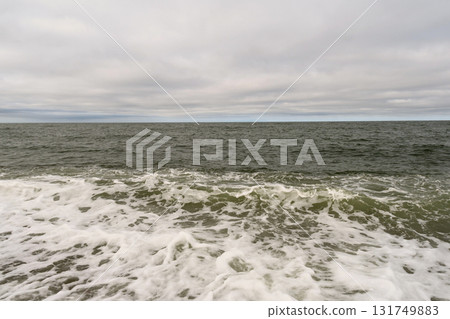 Choppy sea waves under cloudy horizon with foamy surf Choppy sea waves under cloudy horizon with foamy surf 131749883