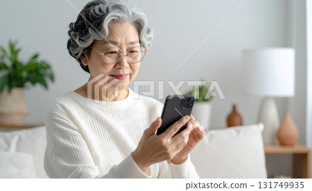 Senior female looking at a smartphone 131749935