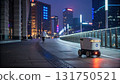 Futuristic autonomous delivery robot with glowing sensors navigating modern city sidewalk night, efficient urban technology for package shipping 131750521