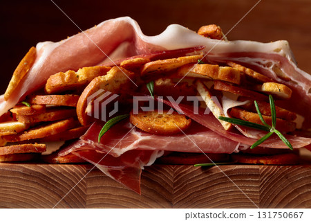 Prosciutto and bruschetta with rosemary. Prosciutto and bruschetta with rosemary. 131750667