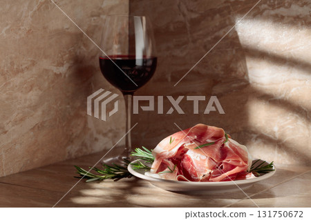 Prosciutto or Spanish jamon with rosemary and red wine. Prosciutto or Spanish jamon with rosemary and red wine. 131750672