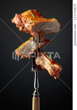 Grilled pork ribs on a fork. 131750675