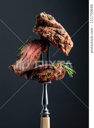 Beef steak on a fork. Beef steak on a fork. 131750686