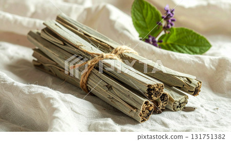 Eco-friendly bundles of herbal smudge sticks tied with natural twine, displayed on linen fabric. Perfect for rituals, aromatherapy, mindfulness, and holistic wellness themes 131751382