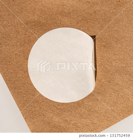 Minimalist round white sticker on brown textured surface with shadow Minimalist round white sticker on brown textured surface with shadow 131752459